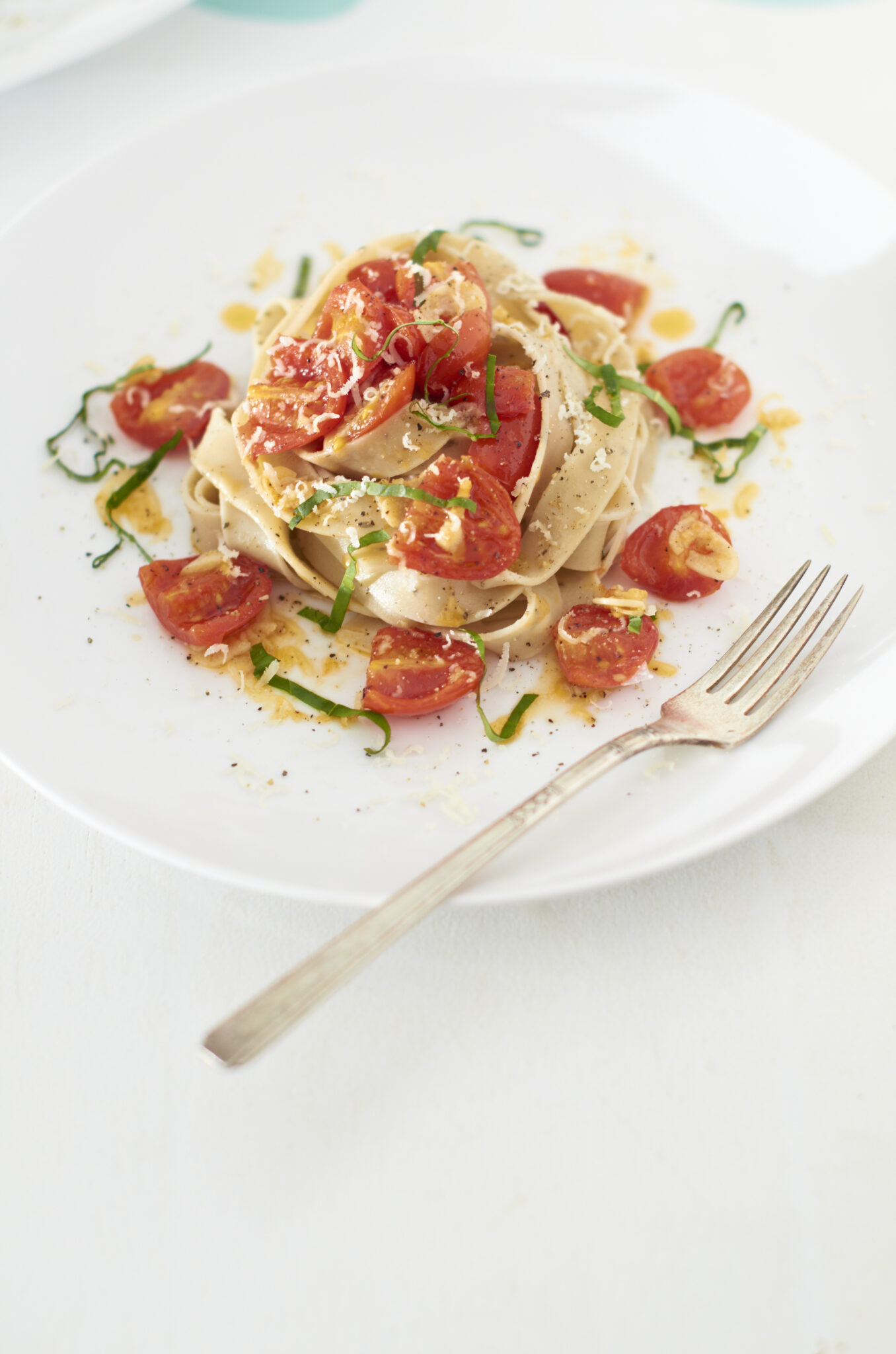 Gourmet pasta dish with elegant presentation on white plate